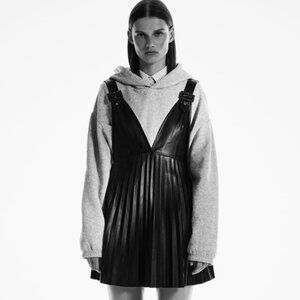 Zara | Faux Leather Pleated Pinafore with Buckles | Black